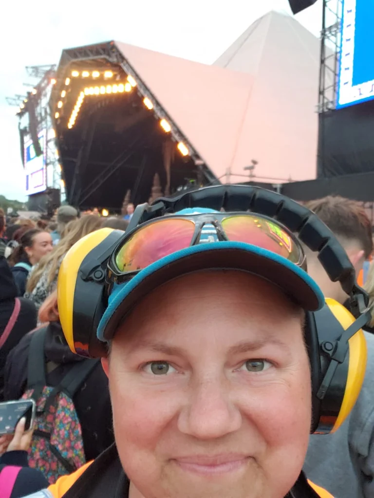 Invictus crew member in ear defenders at a live music event