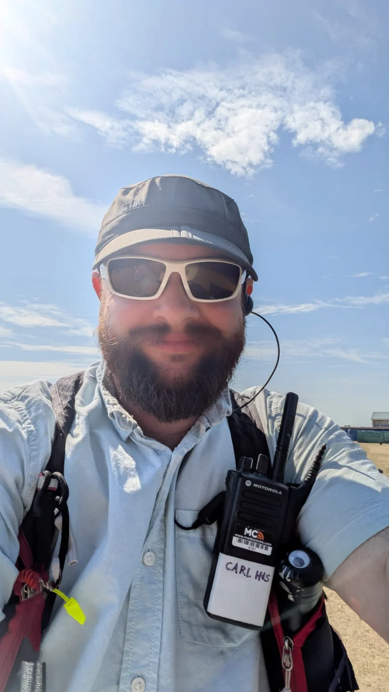 Invictus supervisor on radio during an outdoor event